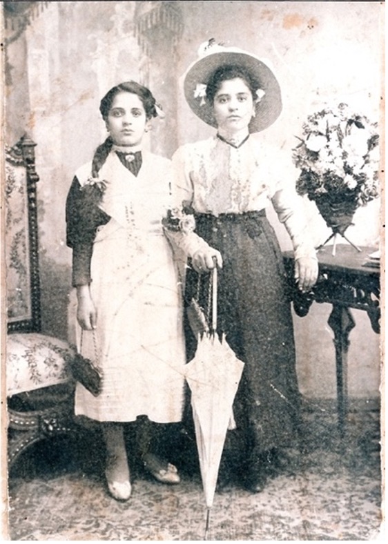 A couple of women posing for the camera Description automatically generated with medium confidence