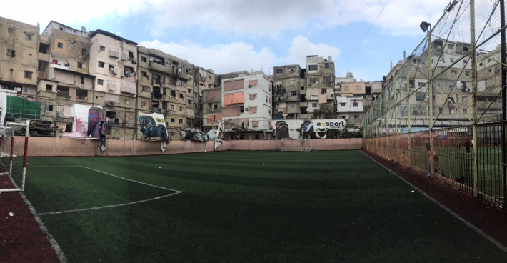 A photo of a football field surrounded by buildings